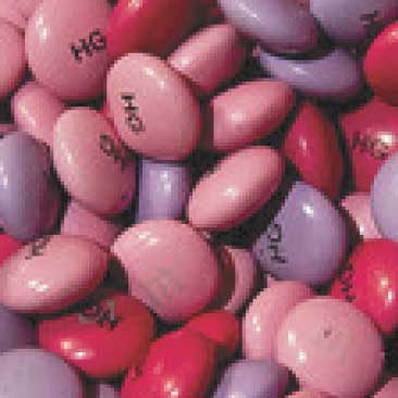 Pink detail of candies bearing the initials of the Bat Mitzvah girl from a Fashionista Bat Mitzvah; Boston Event Planner, Boston Event Planning, Boston Event Stylist, Boston Event Styling